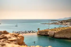 Golden sands and turquoise waters meet at Coral Bay, a beautiful escape near Paphos, Cyprus